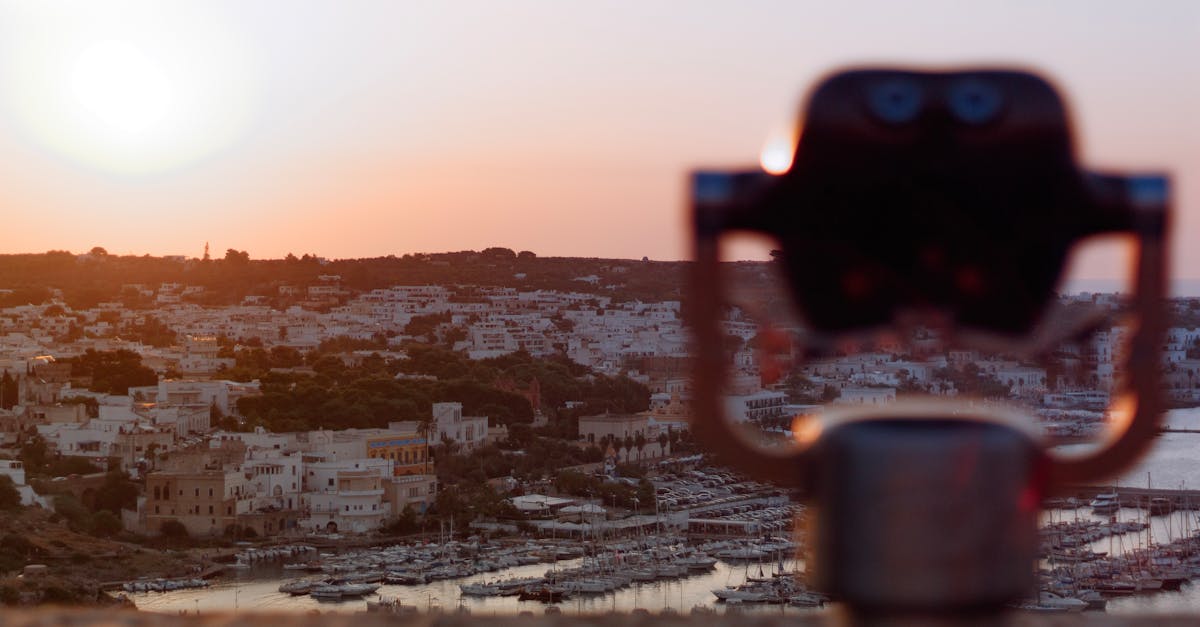 Scenic sunset over Santa Maria di Leuca, Puglia with harbor and telescope in view.