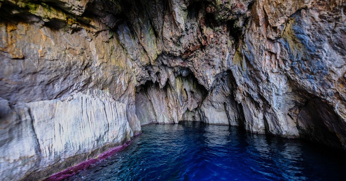Experience the stunning beauty of a natural sea cave with vibrant blue waters and rocky textures.