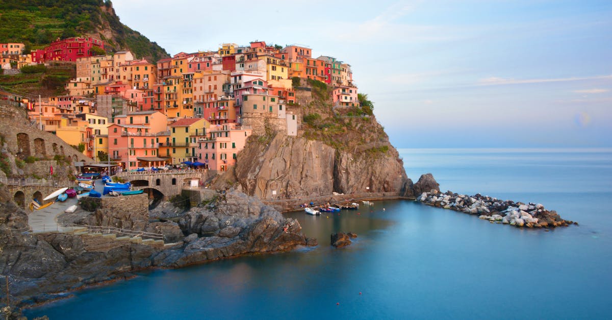 Scenic view of colorful houses and cliffs in Manarola, Liguria, Italy during summer.