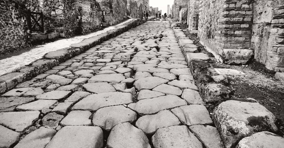 Explore the preserved ancient cobblestone street in Pompeii, Italy, showcasing Roman architecture.