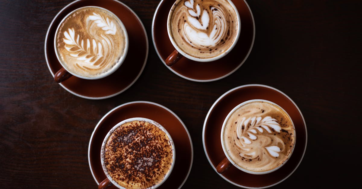 Four beautifully crafted latte art designs in a Sydney coffee shop, showcasing coffee culture.