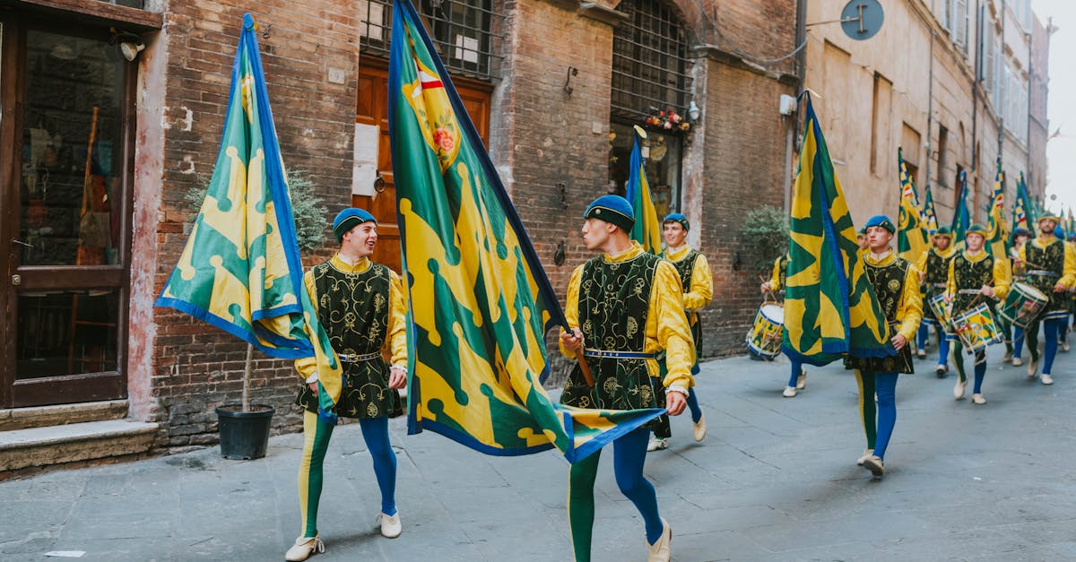 Colorful medieval parade with costumed flag bearers marching in a historic Italian street.