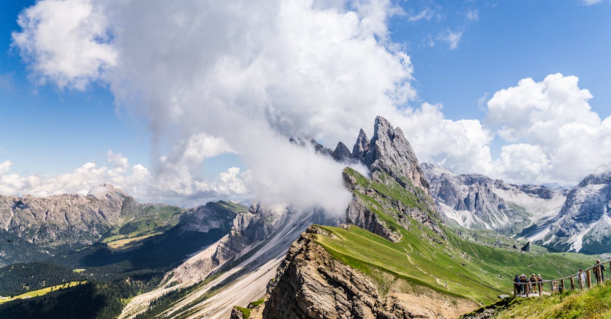 Scenic view of rocky mountain peaks and lush valley, perfect for hiking enthusiasts.