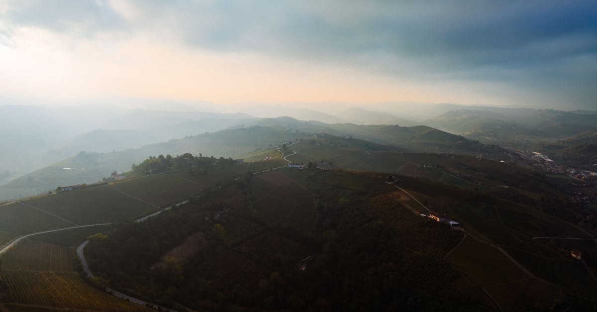Stunning aerial panorama of the rolling hills in Piemonte, Italy captured during sunset.