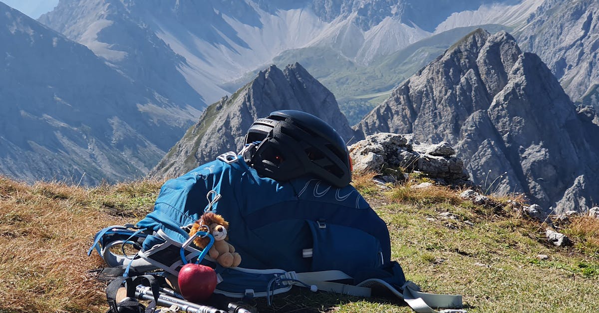 Backpack and hiking gear on a mountain peak providing an adventurous landscape view.