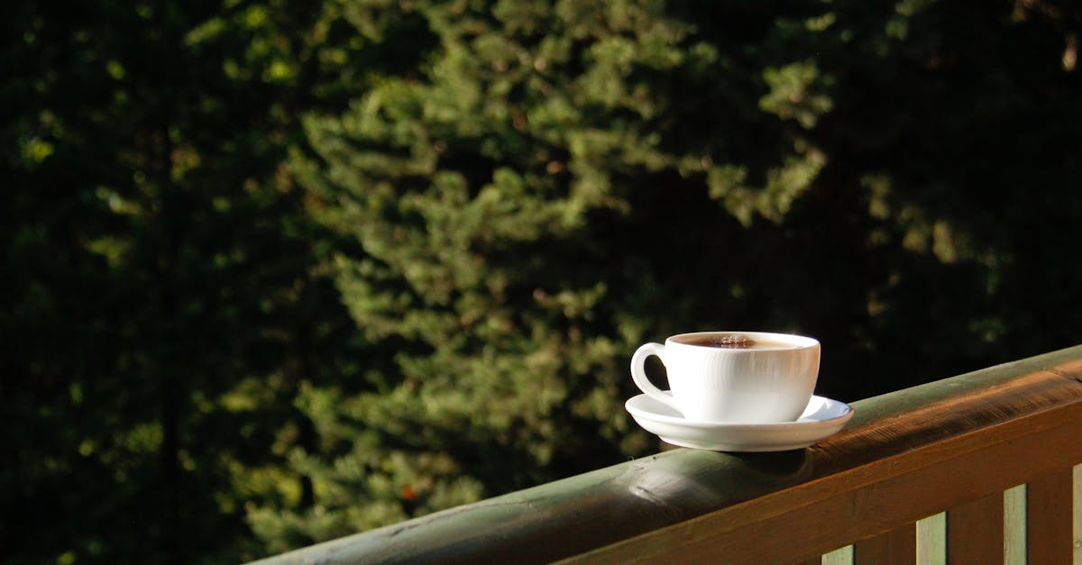 A tranquil scene of a coffee cup on a balcony railing, perfect for relaxation.