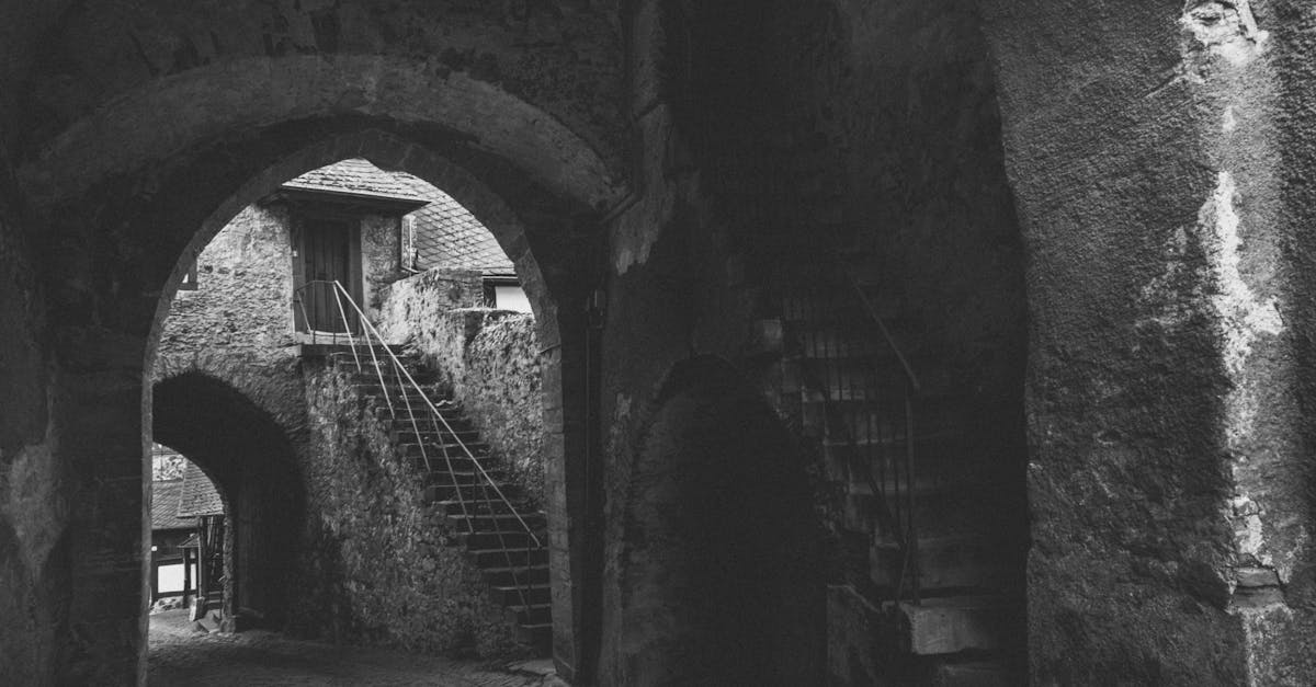 Explore the mysterious stone arches and steps of an ancient building, evoking a sense of history and tradition.