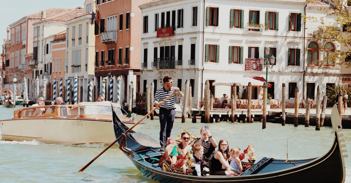 Tourists enjoying a classic gondola ride along the Venetian canals in Venice, Italy.