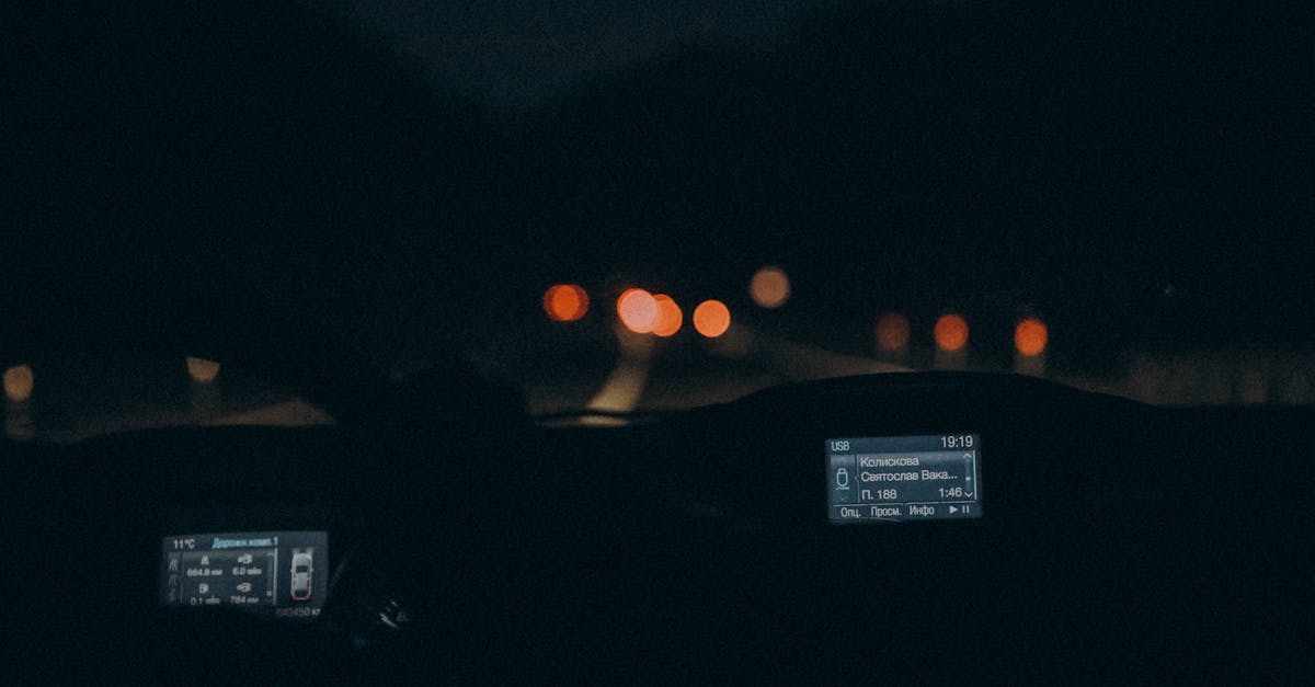 Experience the serene ambiance of night driving with this car interior view featuring a dimly lit dashboard.