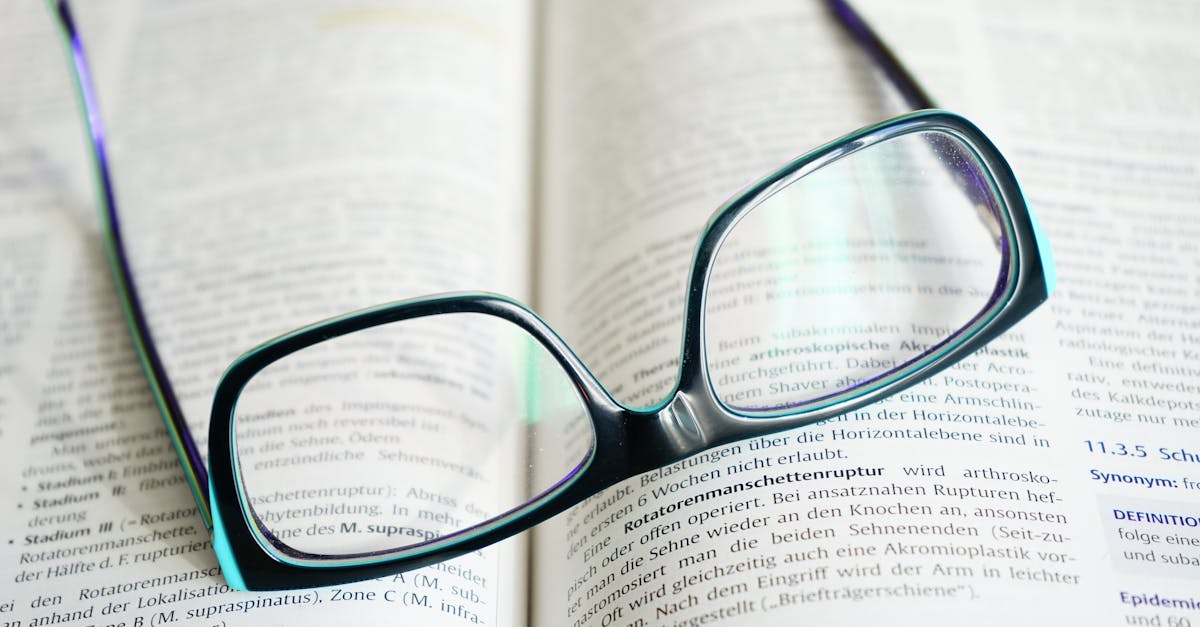 Reading glasses resting on an open textbook, symbolizing study and knowledge.