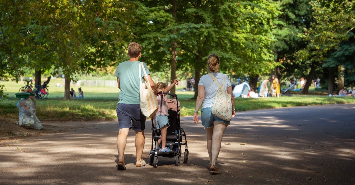 A family enjoying a leisurely walk in a vibrant, sunlit park.