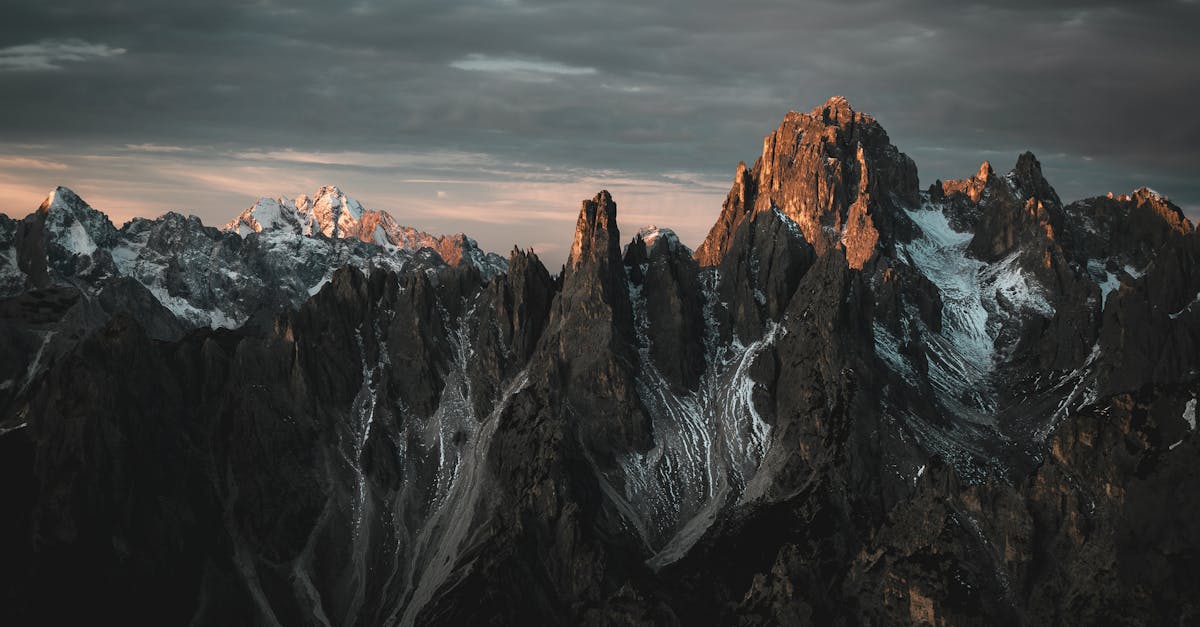 Dramatic mountain peaks at twilight, showcasing rugged landscapes and stunning scenery.