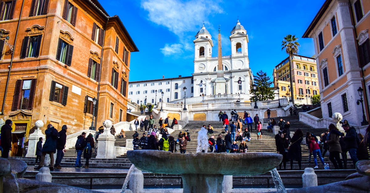 Tourists enjoying a sunny day at the iconic Spanish Steps in Rome, Italy.