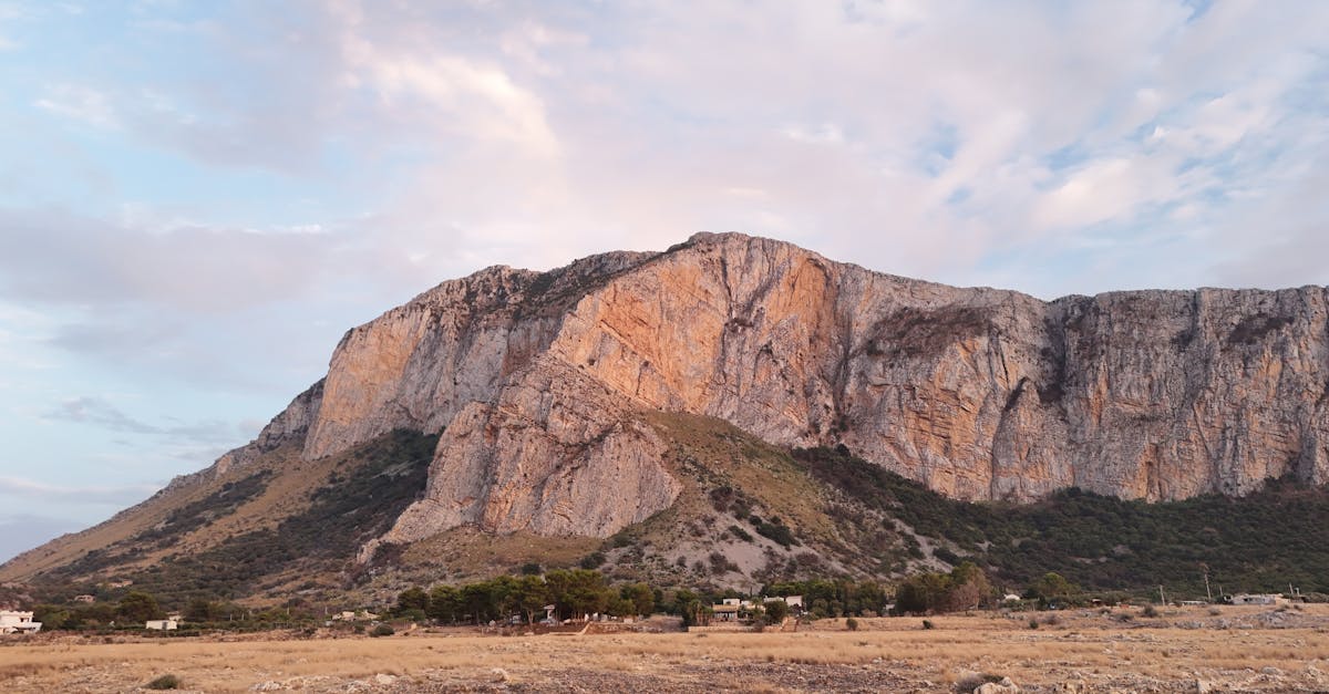 Discover the stunning beauty of a mountainous terrain in Sicily during a vibrant summer sunset.