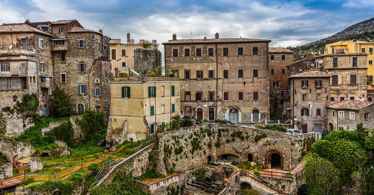 Charming historic buildings in Tivoli, Italy under a cloudy sky.