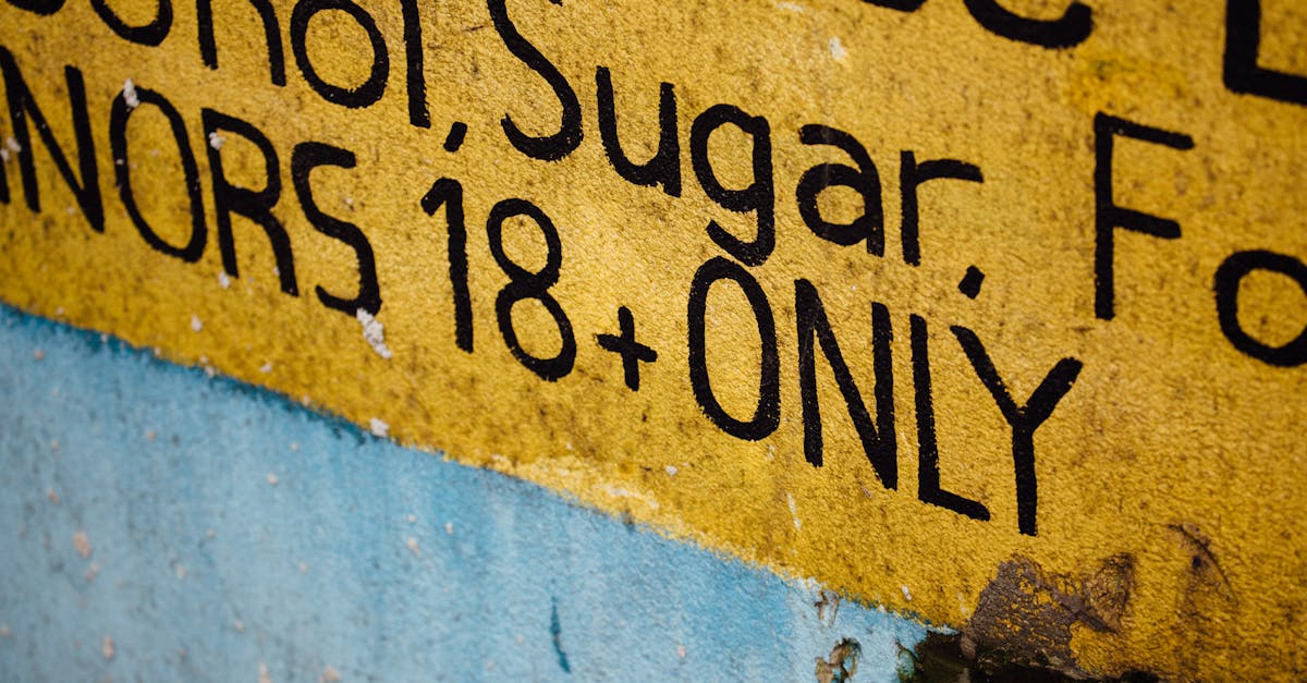 Yellow warning sign stating 'MINORS 18+ ONLY' with visible text and textured background.