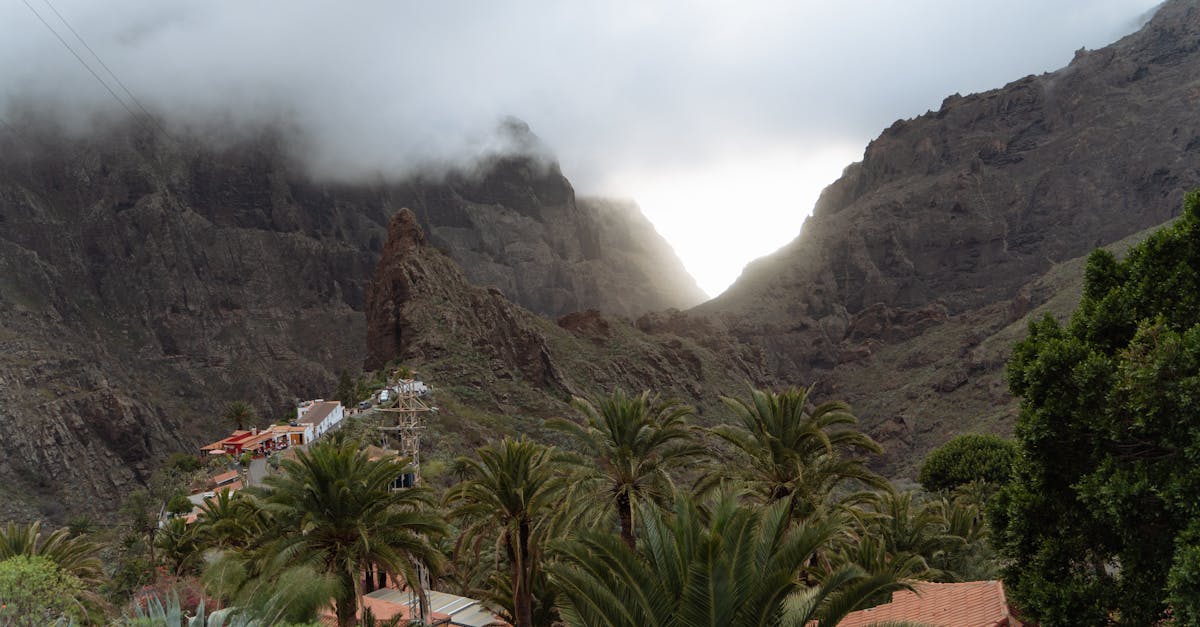 Dramatic view of Masca Village amidst rugged mountains and moody clouds in the Canary Islands.