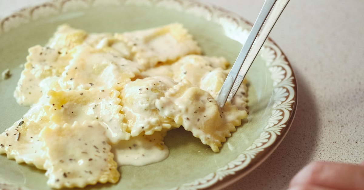 Close-up of ravioli with creamy sauce on a plate in Ankara, Türkiye.
