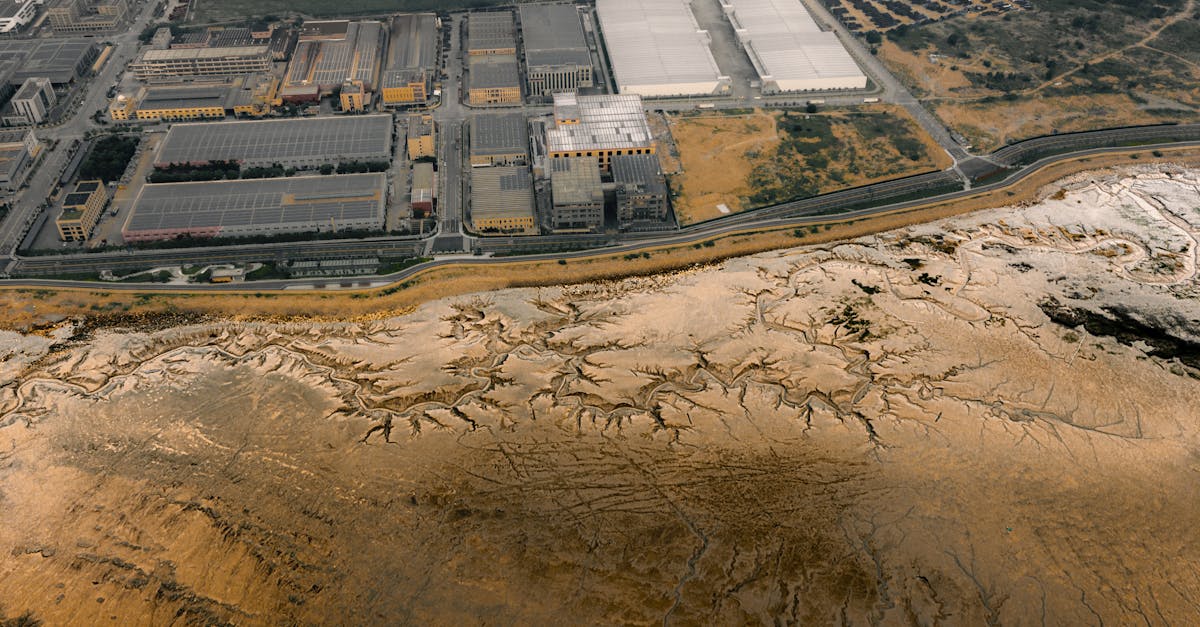 Aerial photo depicting industrial buildings adjacent to salt flats.