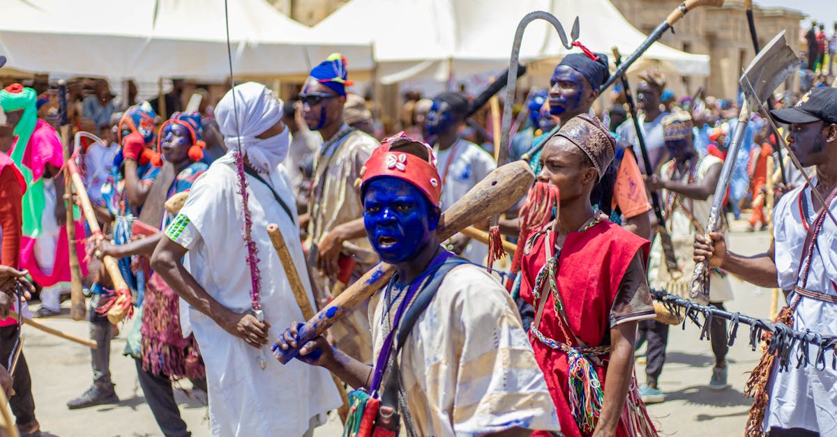 Colorful outdoor festival with people in traditional attire and painted faces.