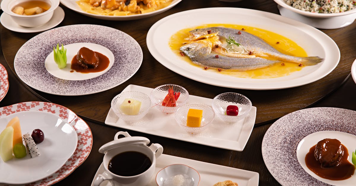 An elegant display of Chinese banquet dishes featuring fish, desserts, and vibrant accompaniments.