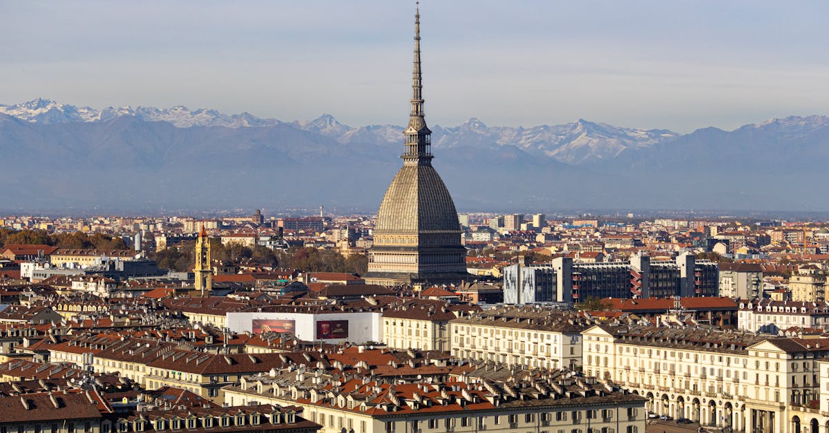 Discover the stunning cityscape of Turin with the iconic Mole Antonelliana and the Alps in the background.