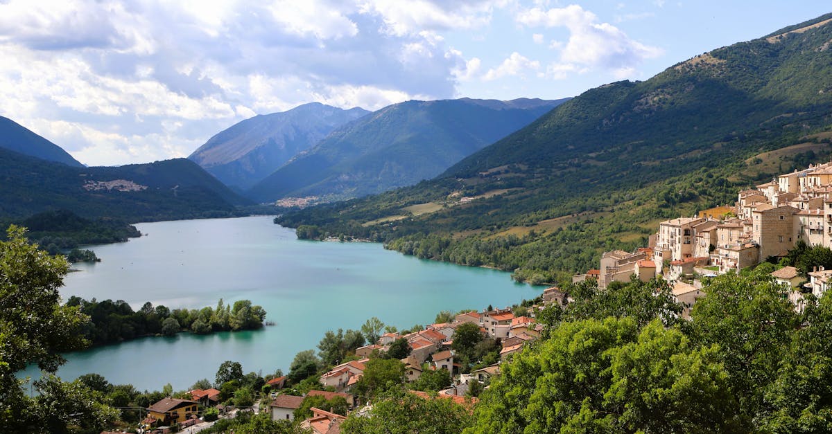 Breathtaking panoramic view of Villetta Barrea with stunning lake and lush mountains in Abruzzo, Italy.