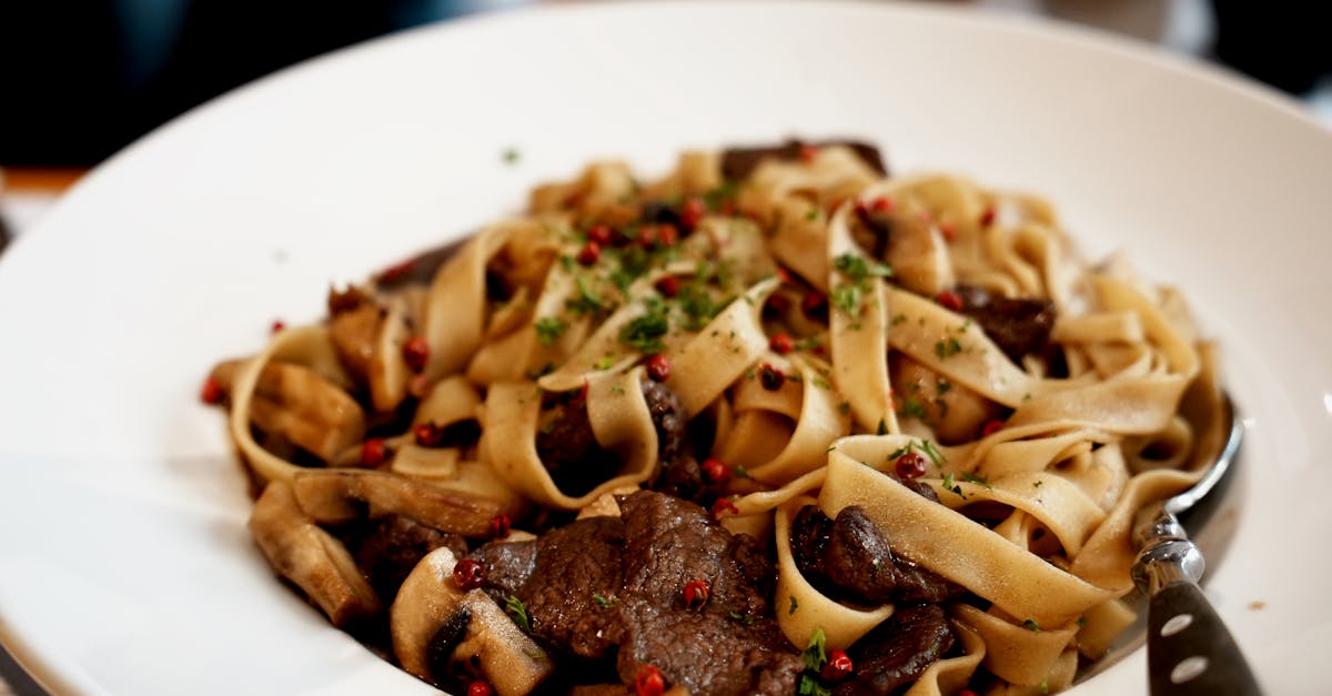 A mouthwatering dish of beef tagliatelle garnished with fresh herbs and spices.