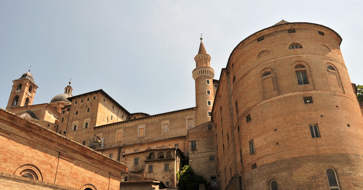 Capture of Palazzo Ducale's intricate architecture in Urbino, showcasing Renaissance design under a clear sky.
