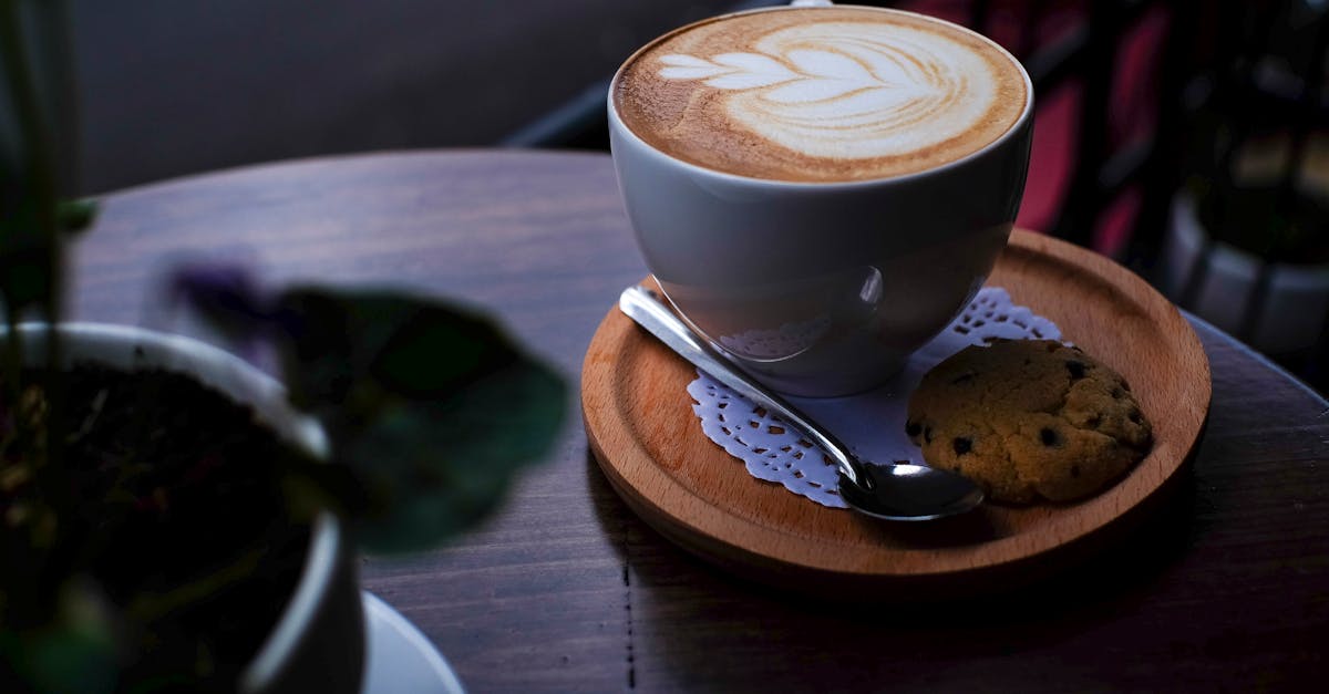 Elegant cappuccino with latte art served with a cookie in Nha Trang, Vietnam.