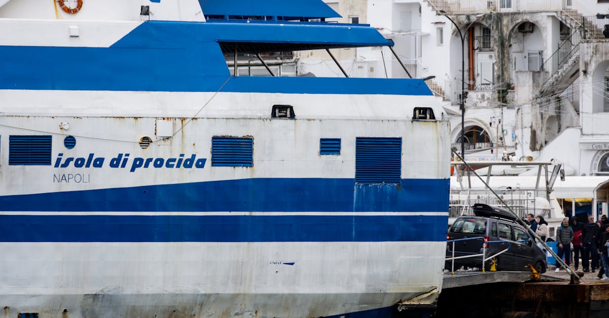 View of Isola di Procida ferry at a port in Naples, Italy with Mediterranean architecture.