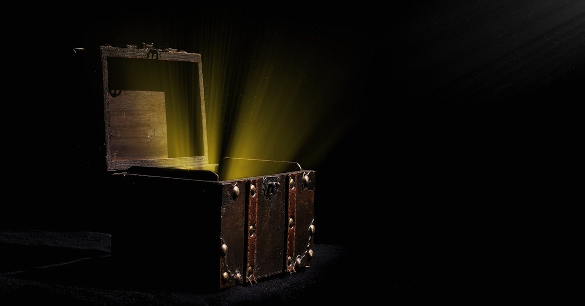 Open wooden chest emitting a mysterious glowing light in a dark room.