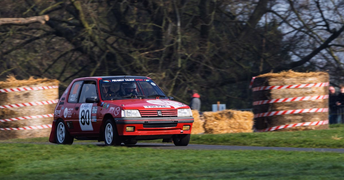 Exciting motorsport at Weston Park with a Peugeot 205 rally car racing through the course.