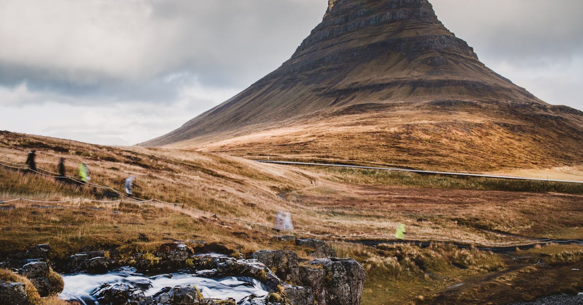 Explore the breathtaking landscape of Kirkjufell, Iceland with its iconic mountain and cascading stream.