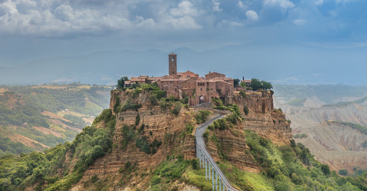 Stunning view of Civita di Bagnoregio, an ancient hilltop village in Italy, surrounded by lush landscape.
