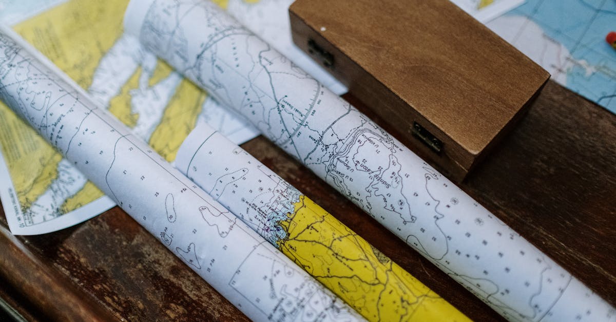 Close-up of rolled nautical maps on a wooden table, perfect for navigation themes.