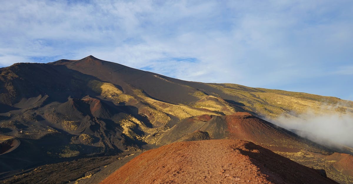 Breathtaking view of Mount Etna, showcasing its volcanic landscape under a clear sky in Sicily.