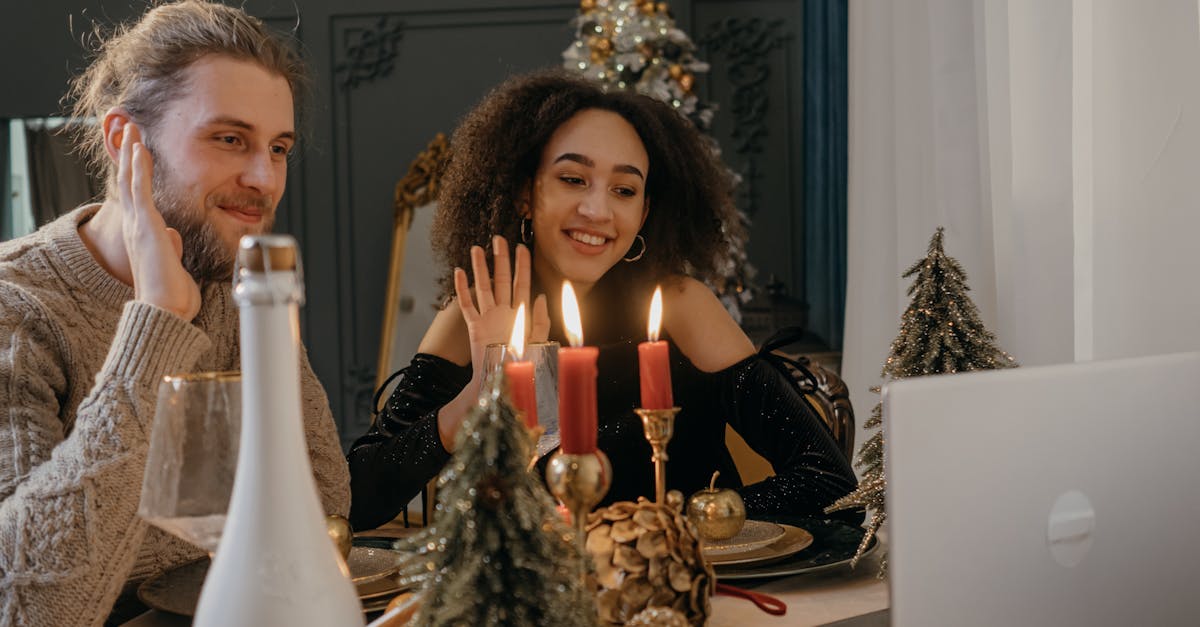 Happy interracial couple enjoying a festive Christmas video call together indoors.