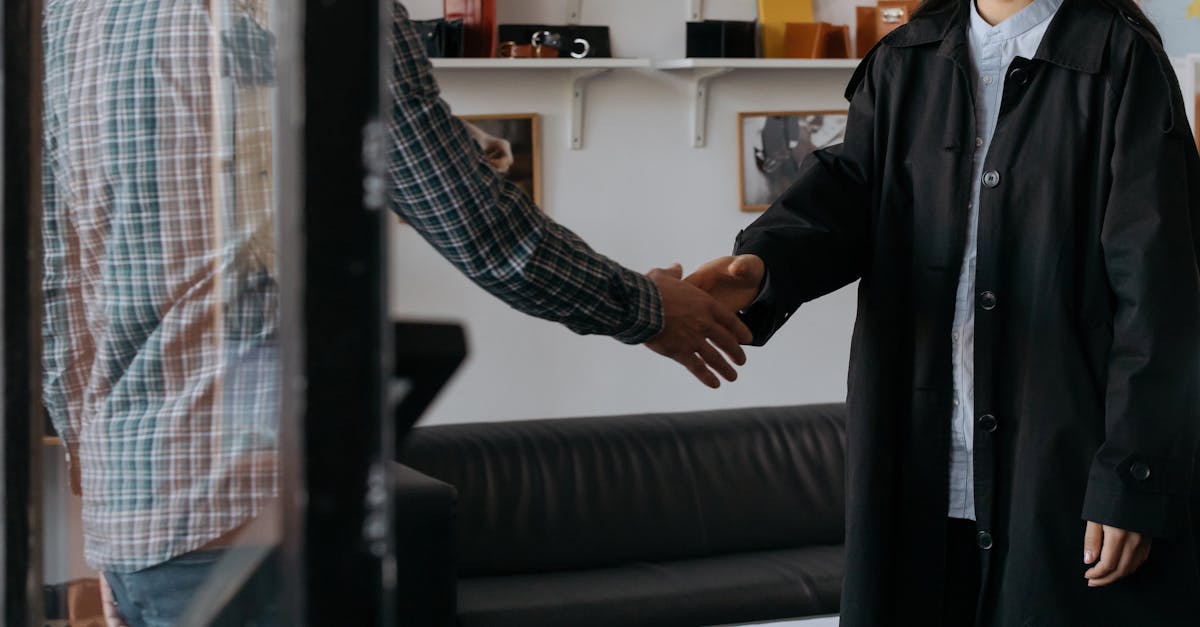 Two professionals engage in a handshake, symbolizing a successful agreement in a contemporary office.