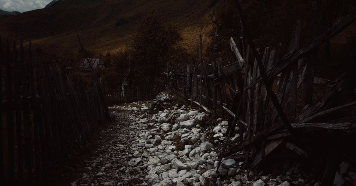 A moody rocky path through a rustic fence in Theth, Albania.