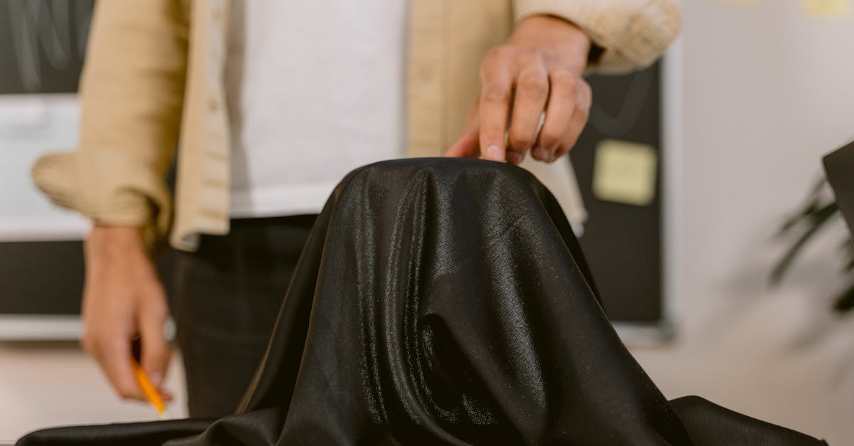 Close-up of a hand pulling a black cloth, showcasing a mysterious setup.
