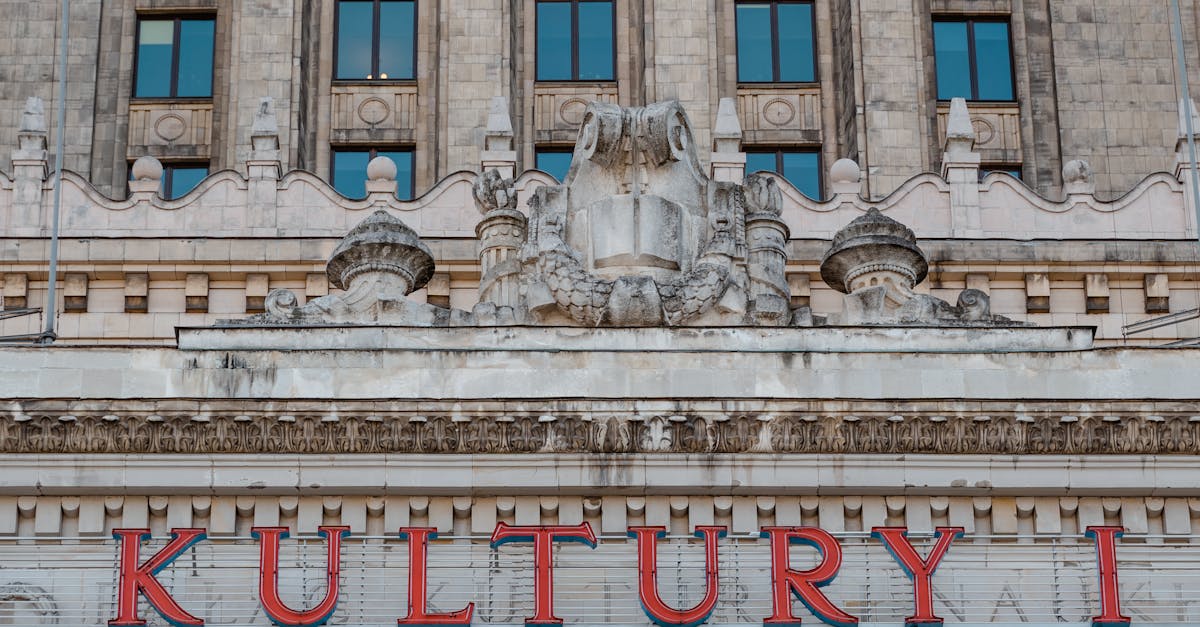 Close-up of a historic building facade with the sign 'KULTURY' in bold red letters.