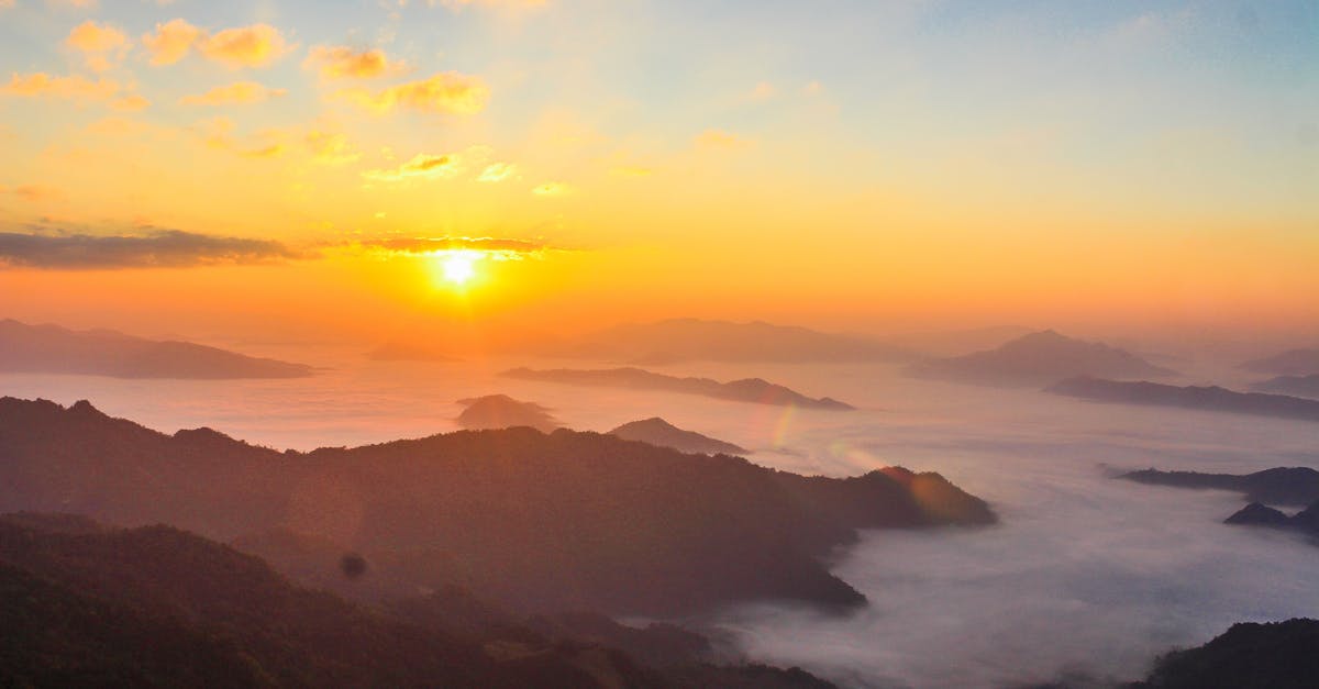 Stunning sunrise scene with mist-covered valleys and majestic mountain landscape.