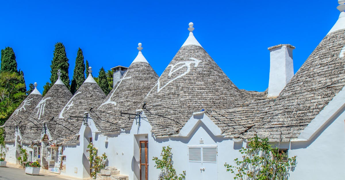Discover the unique architecture of Trulli houses in Alberobello, Italy on a bright sunny day.