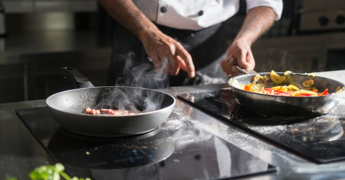 A chef skillfully prepares a meal with fresh ingredients on an electric stove, emphasizing culinary expertise.