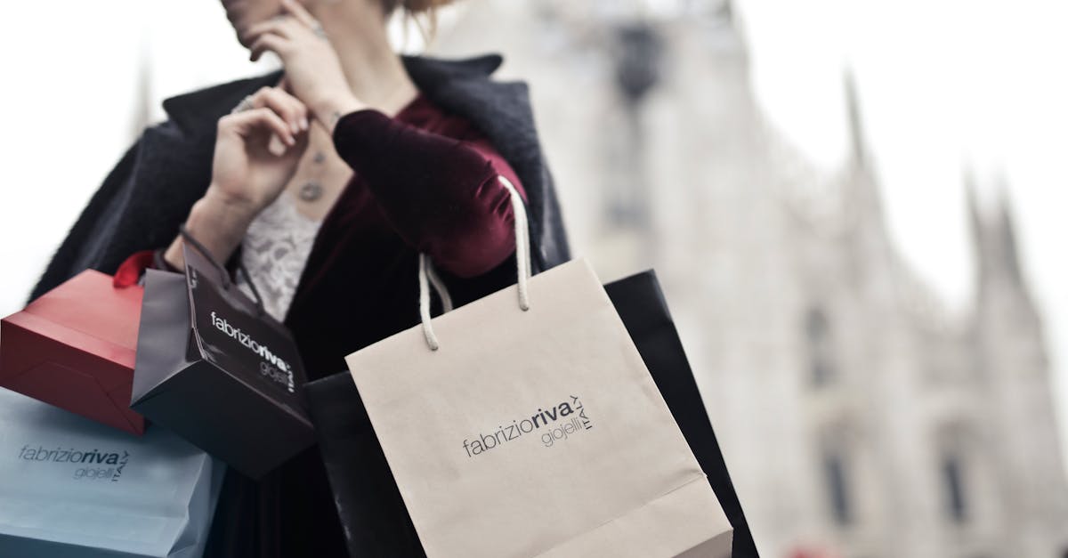 Stylish woman holding designer shopping bags near Milan's iconic Duomo. Urban fashion and lifestyle concept.